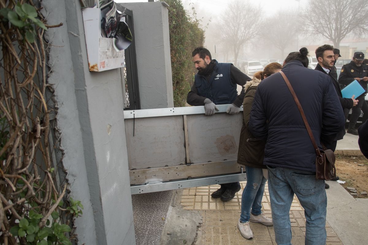 Los cerrajeros cargando la puerta anti okupas para colocarla en el piso de la familia jerezana. FOTO: MANU GARCÍA. 