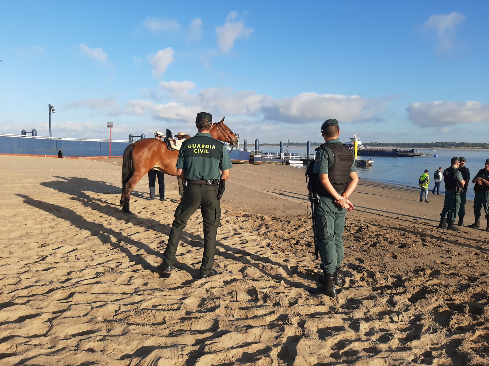 Agentes de la Guardia Civil controlando el tránsito por la playa de Bajo Guía hasta las barcazas.