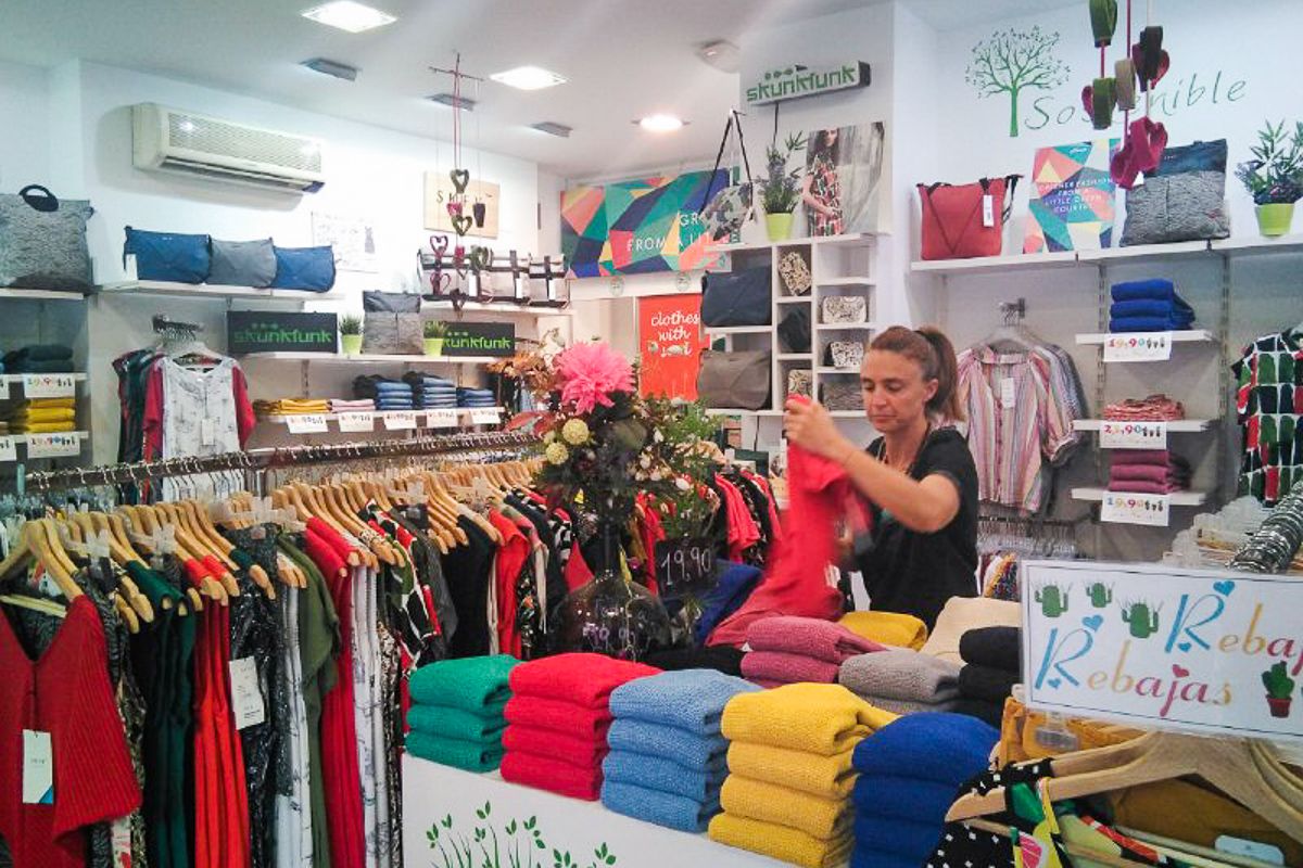 Marta, dependienta, arreglando algunas de las prendas de su tienda. FOTO: LAVOZDELSUR.ES