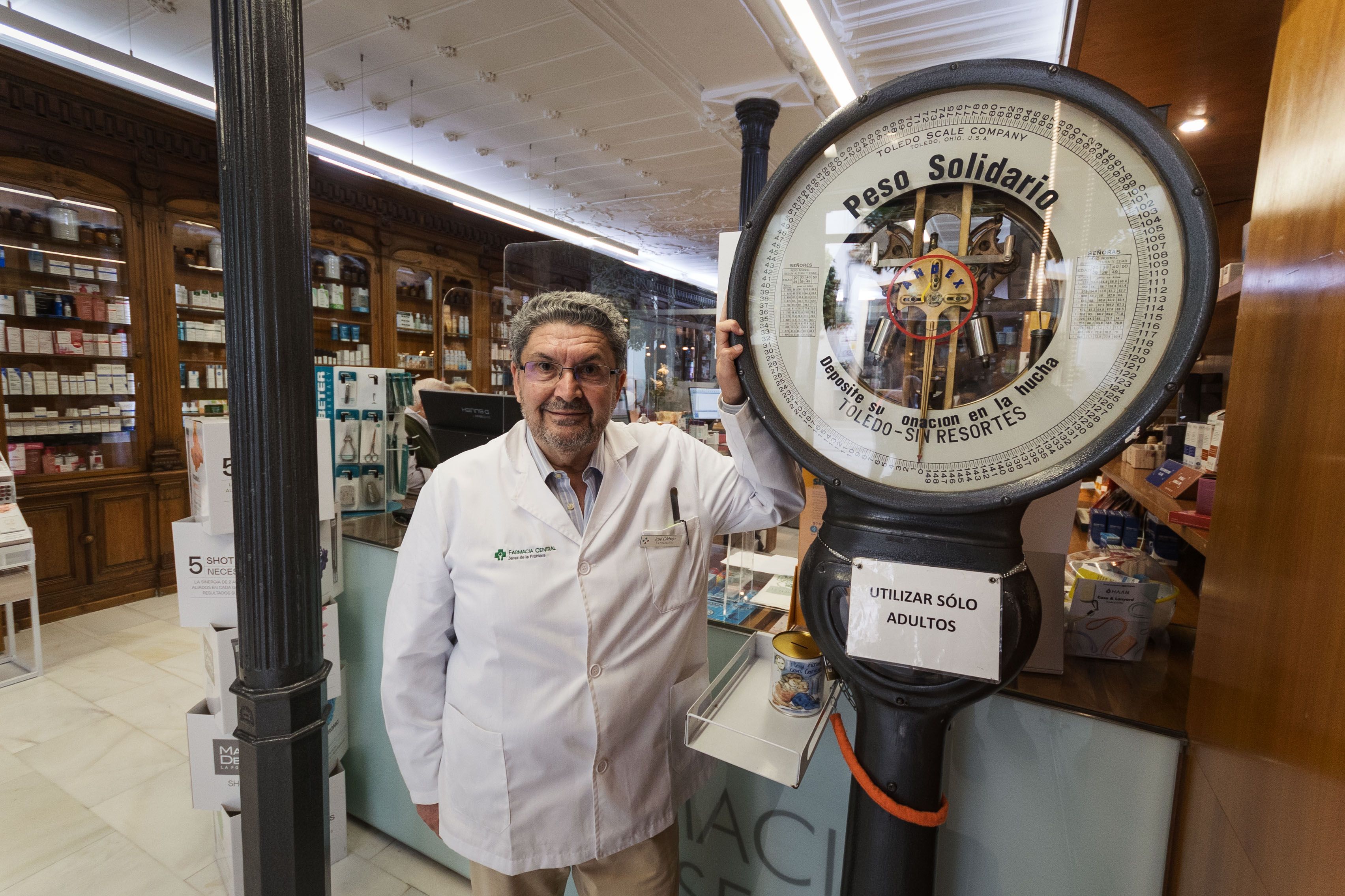 Manuel Carbajo junto a la famosa báscula "que ha pisado casi todo Jerez", en la Farmacia Central de Jerez.