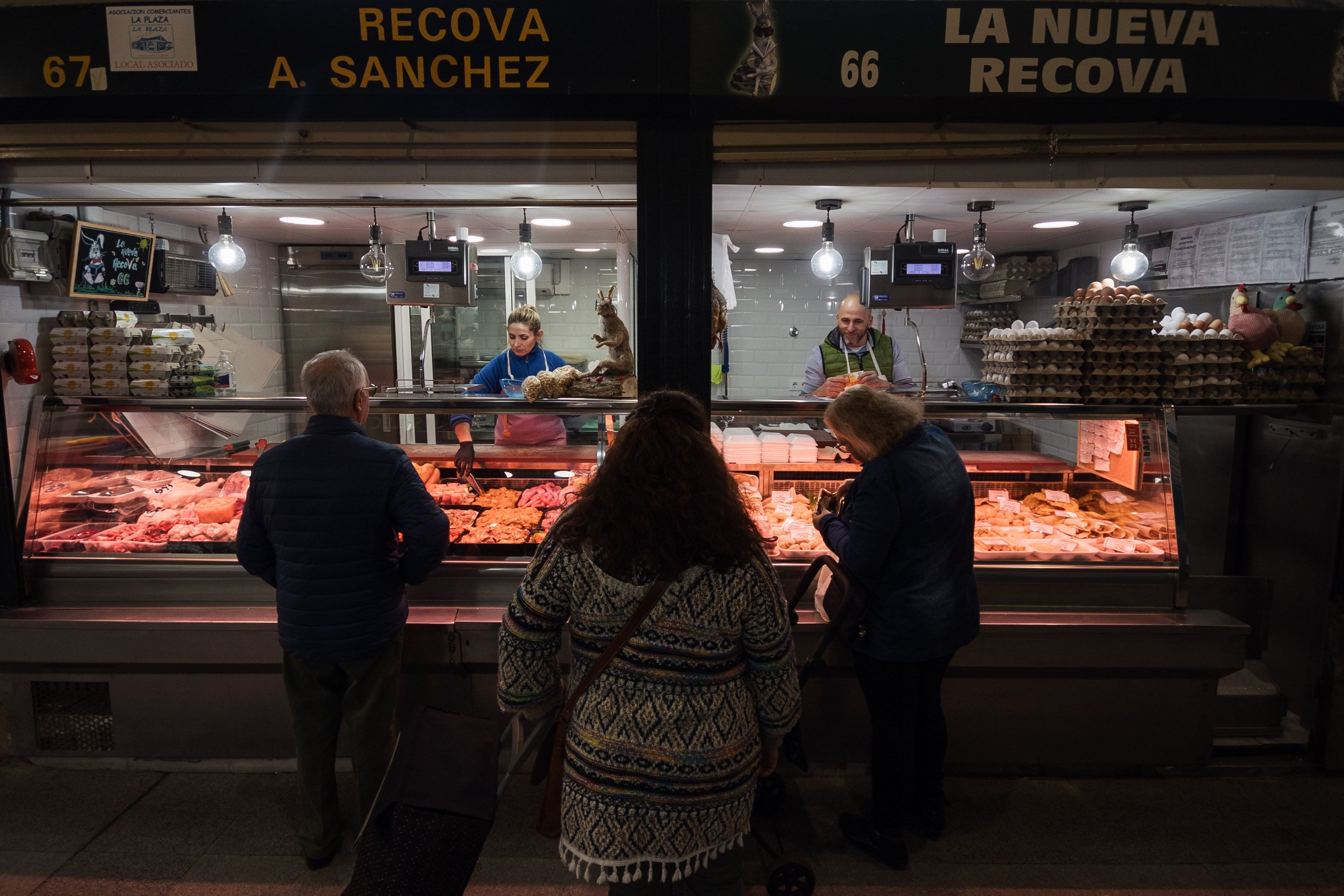 Clientes esperando su turno en un puesto de la Plaza.    MANU GARCÍA