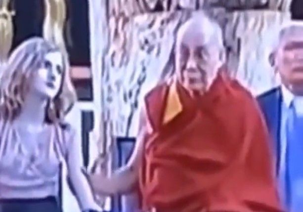Dalái Lama acariciando a una niña. 