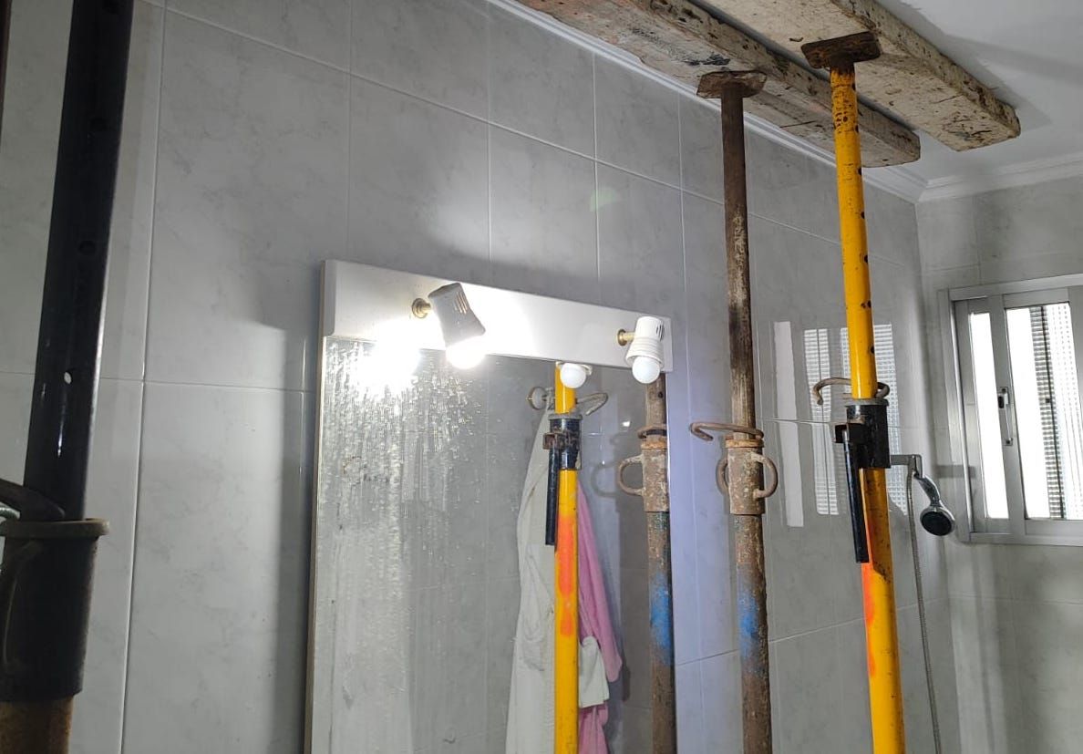 Puntales instalados en el baño tras la caída del techo.
