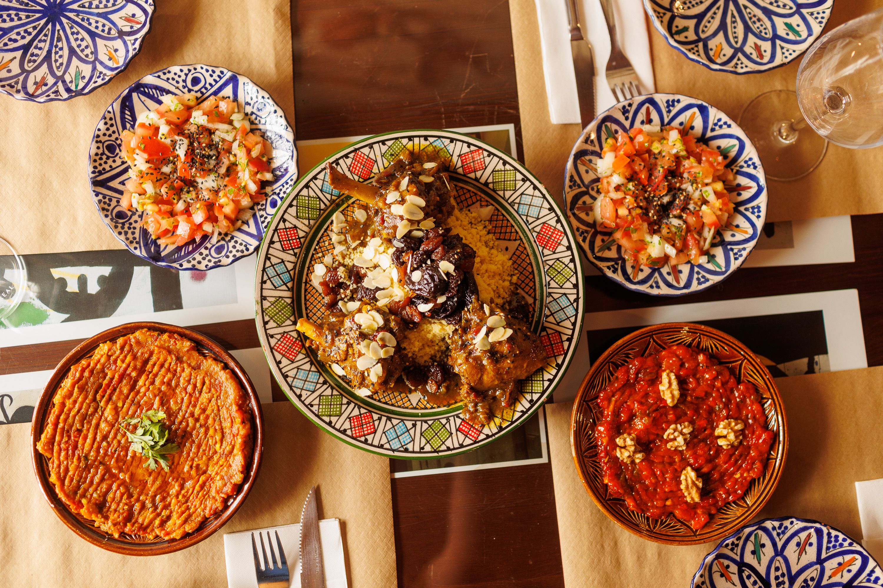 Entrantes como el zaalok, abajo izqda, o la taktouka, abajo dcha, junto al tajin de cordero y a la ensalada marroquí.    JUAN CARLOS TORO