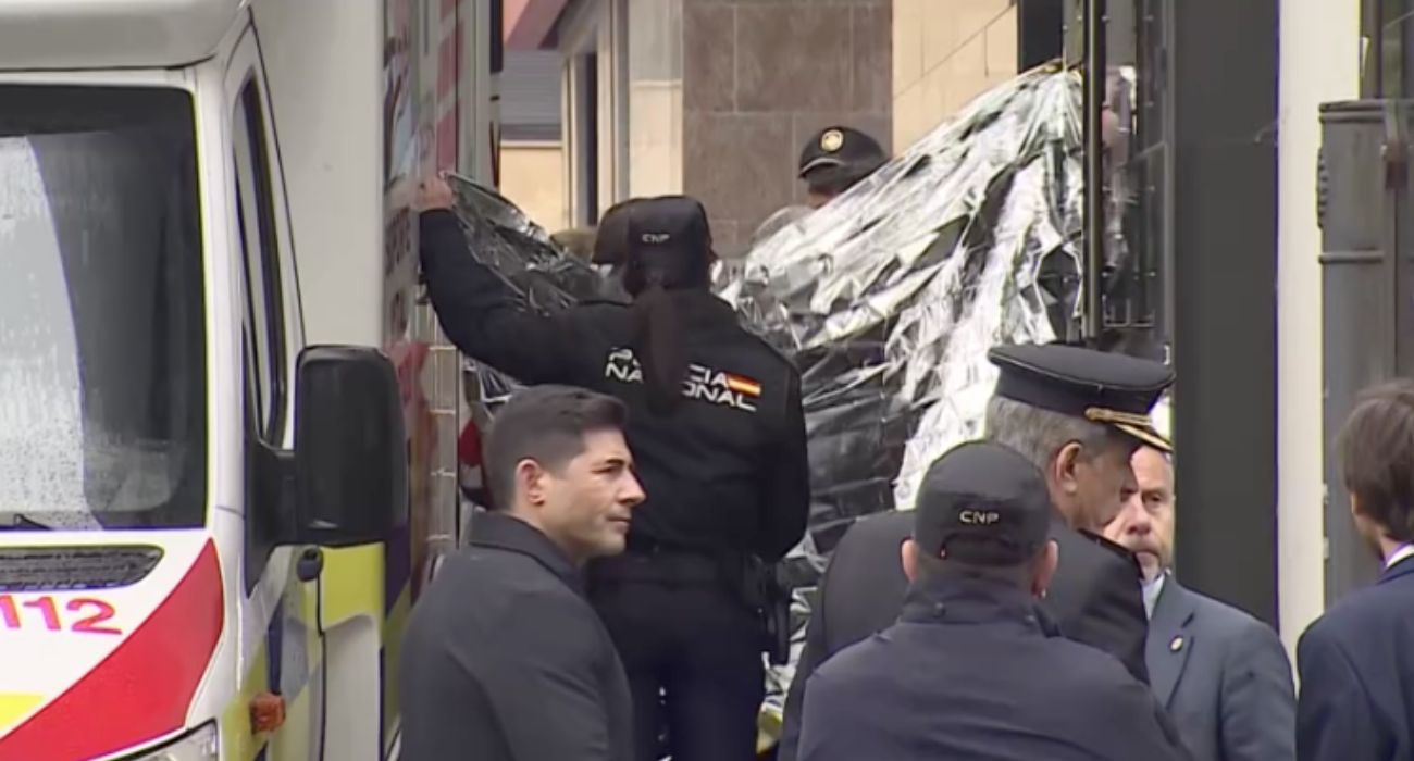 Agentes de la Policía Nacional tapan el lugar donde murieron las mellizas tras caer desde un sexto piso.   RTVE