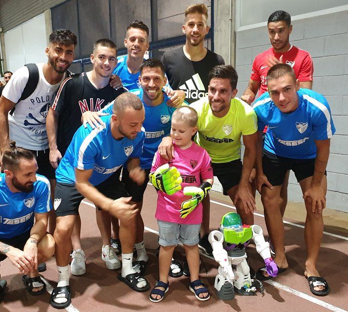 El pequeño Cristian junto a la plantilla del Málaga C.F. equipo al que era aficionado, en una imagen que el club ha publicado en Twitter.