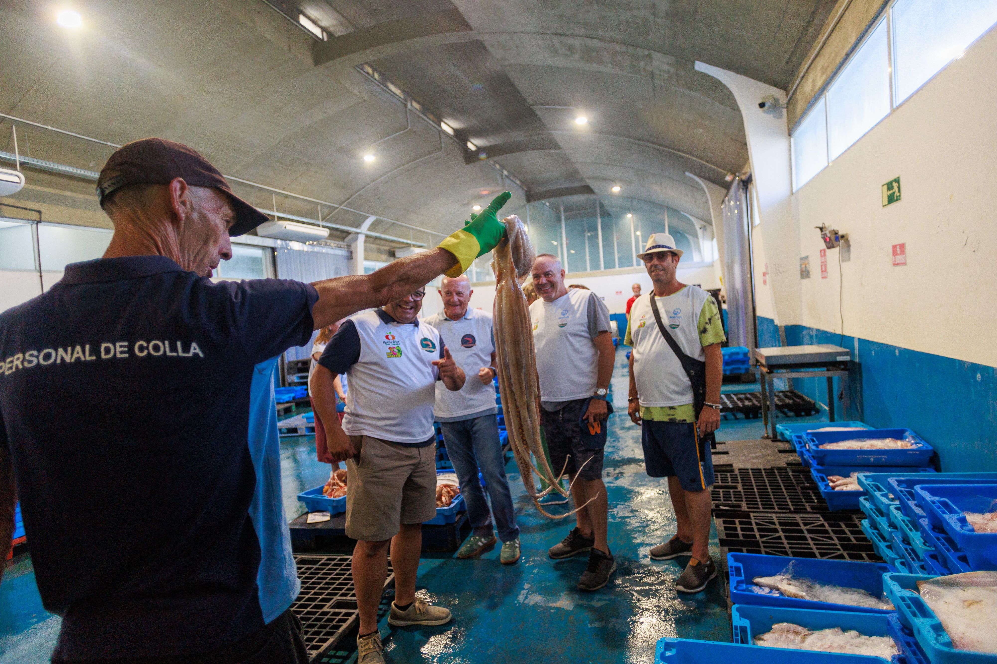 Un operario de la lonja muestra ejemplares.