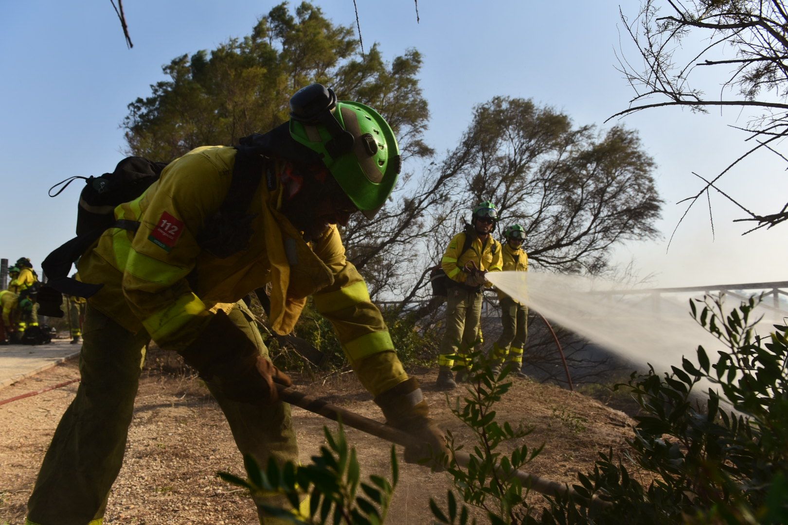 Bomberos del Infoca trabajando en la extinción del incendio de Puerto Real.