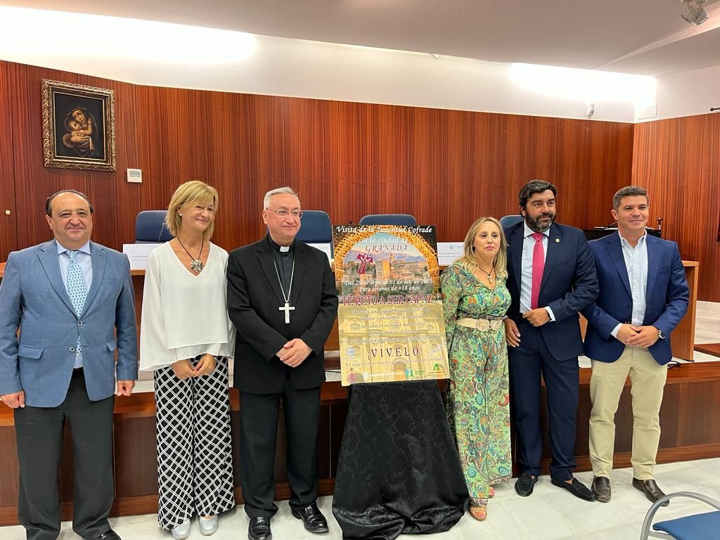 El obispo, delegados municipales y responsables de la Unión de Hermandades posando junto al cartel de las jornadas. 
