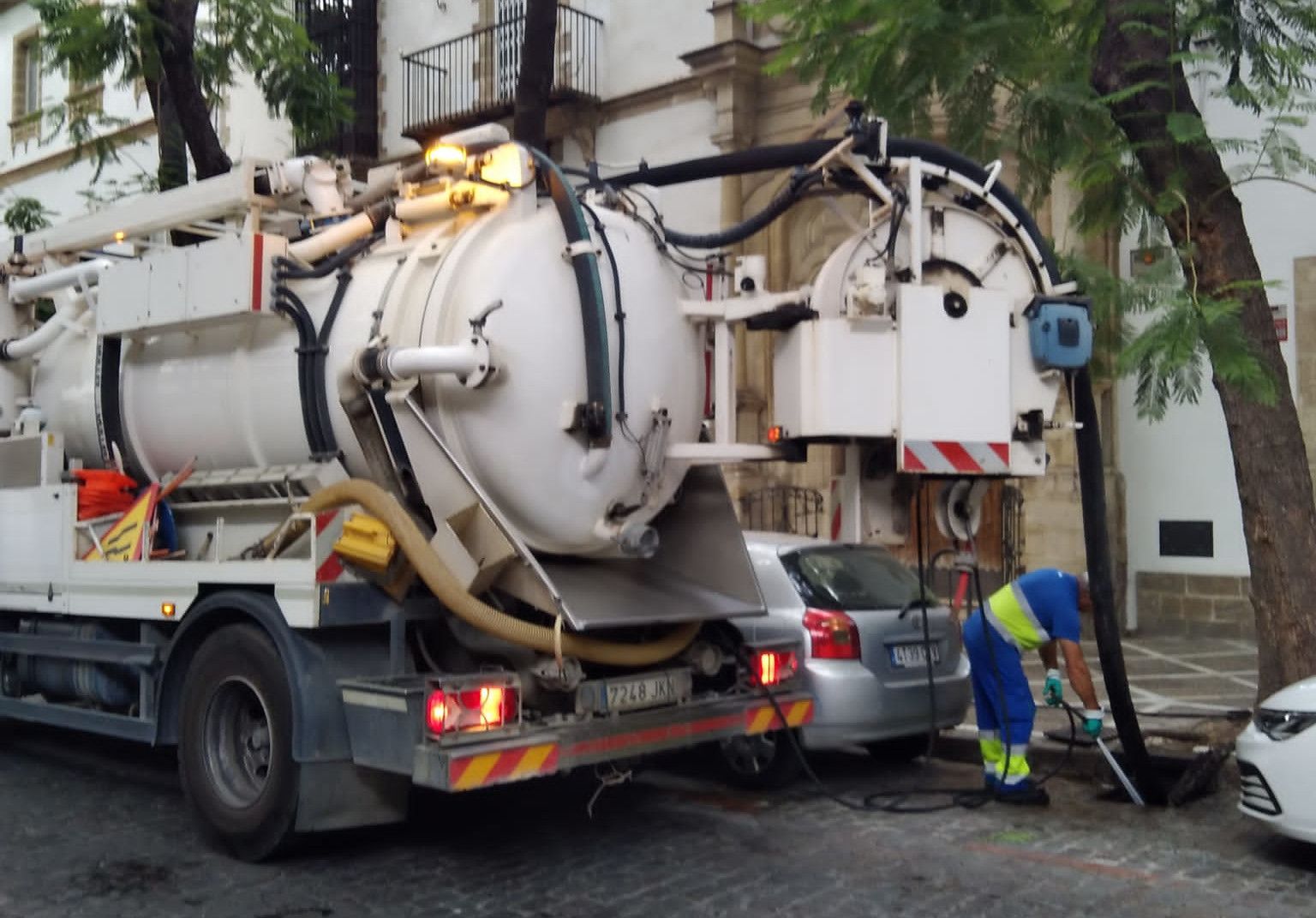 Un operario limpia los imbornales en el centro de Jerez.