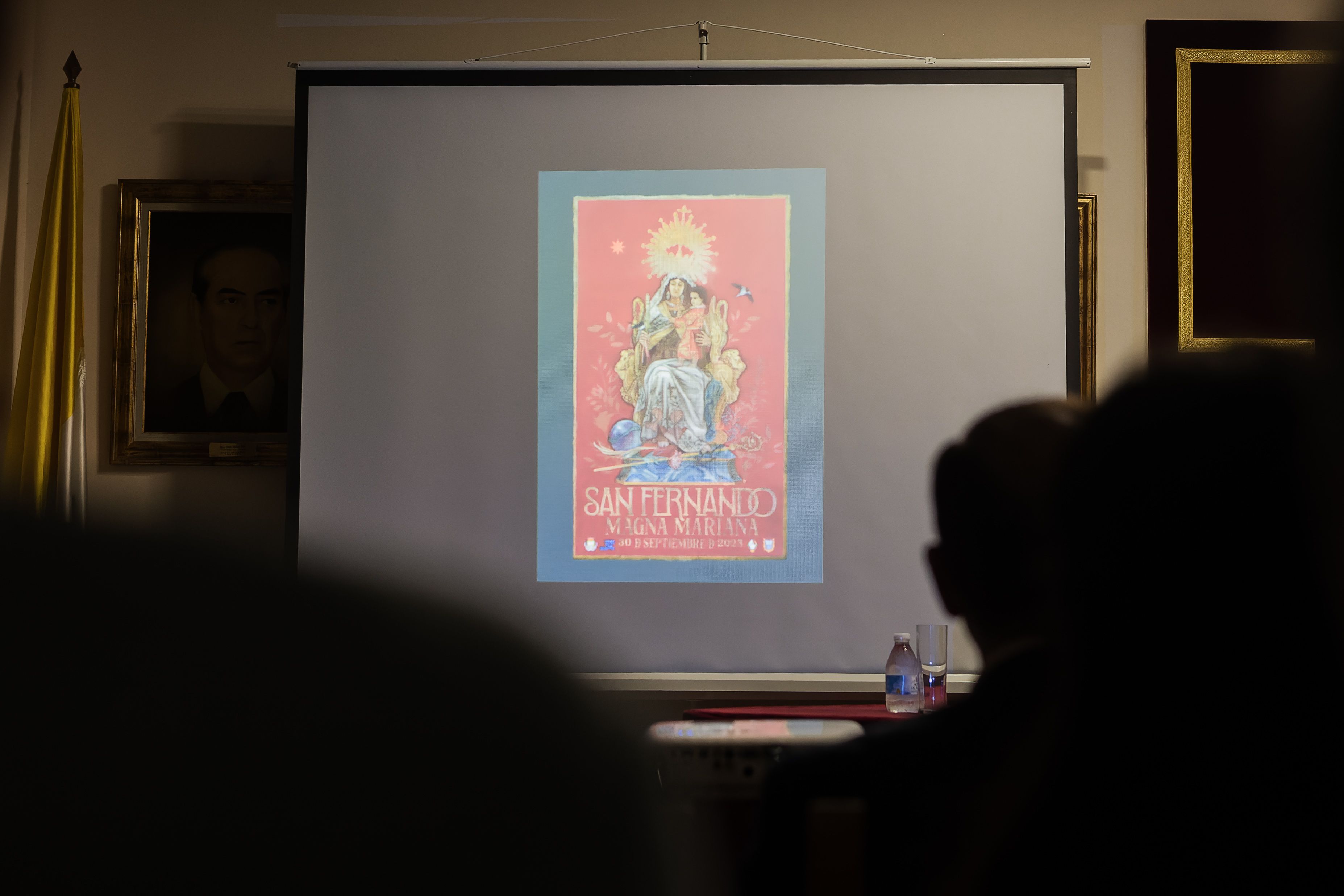 El cartel de la magna proyectado en un pantalla durante la presentación.    CANDELA NÚÑEZ