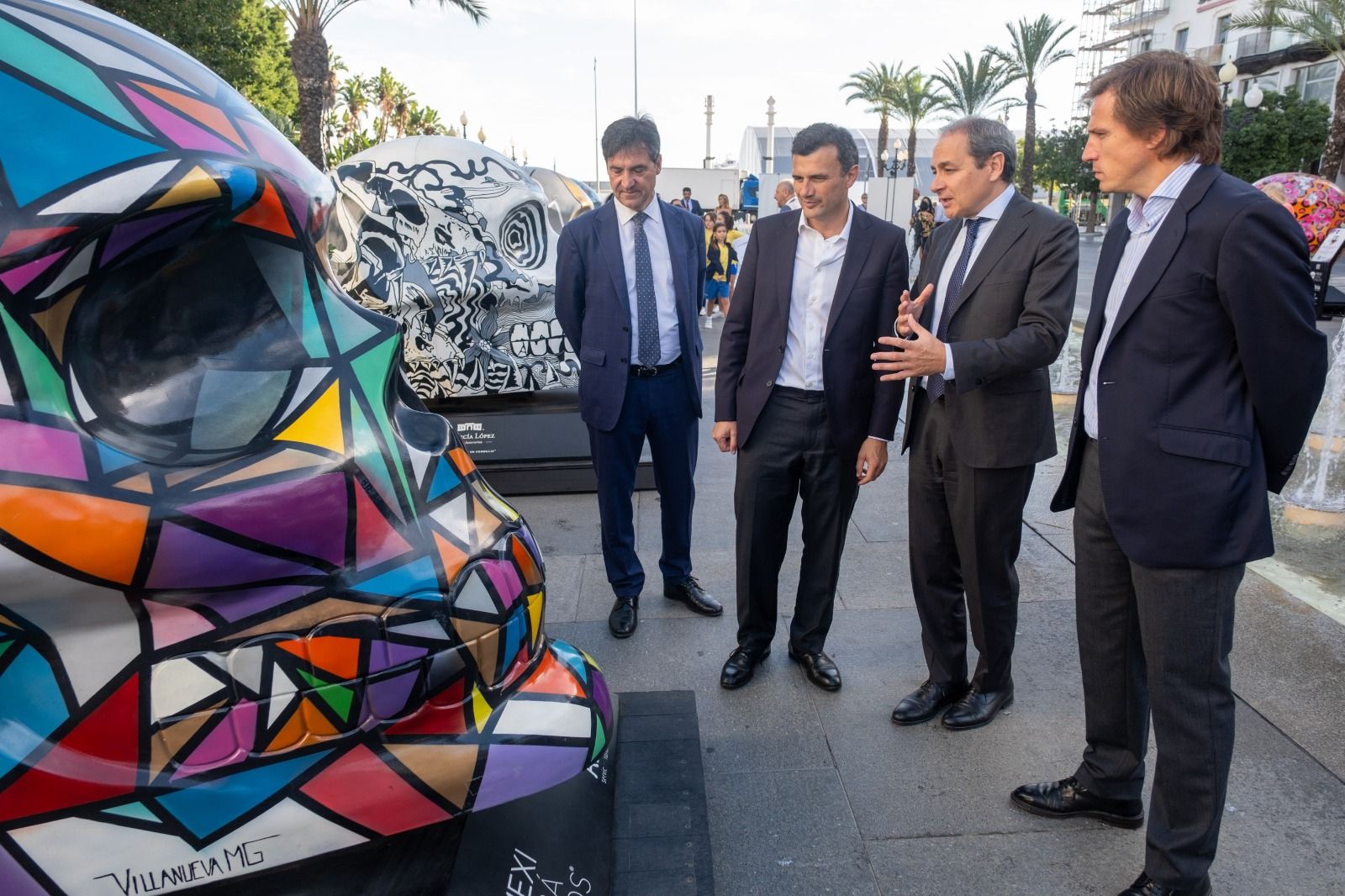 El alcalde y delegados ante uno de los diez grandes cráneos expuestos en las calles.