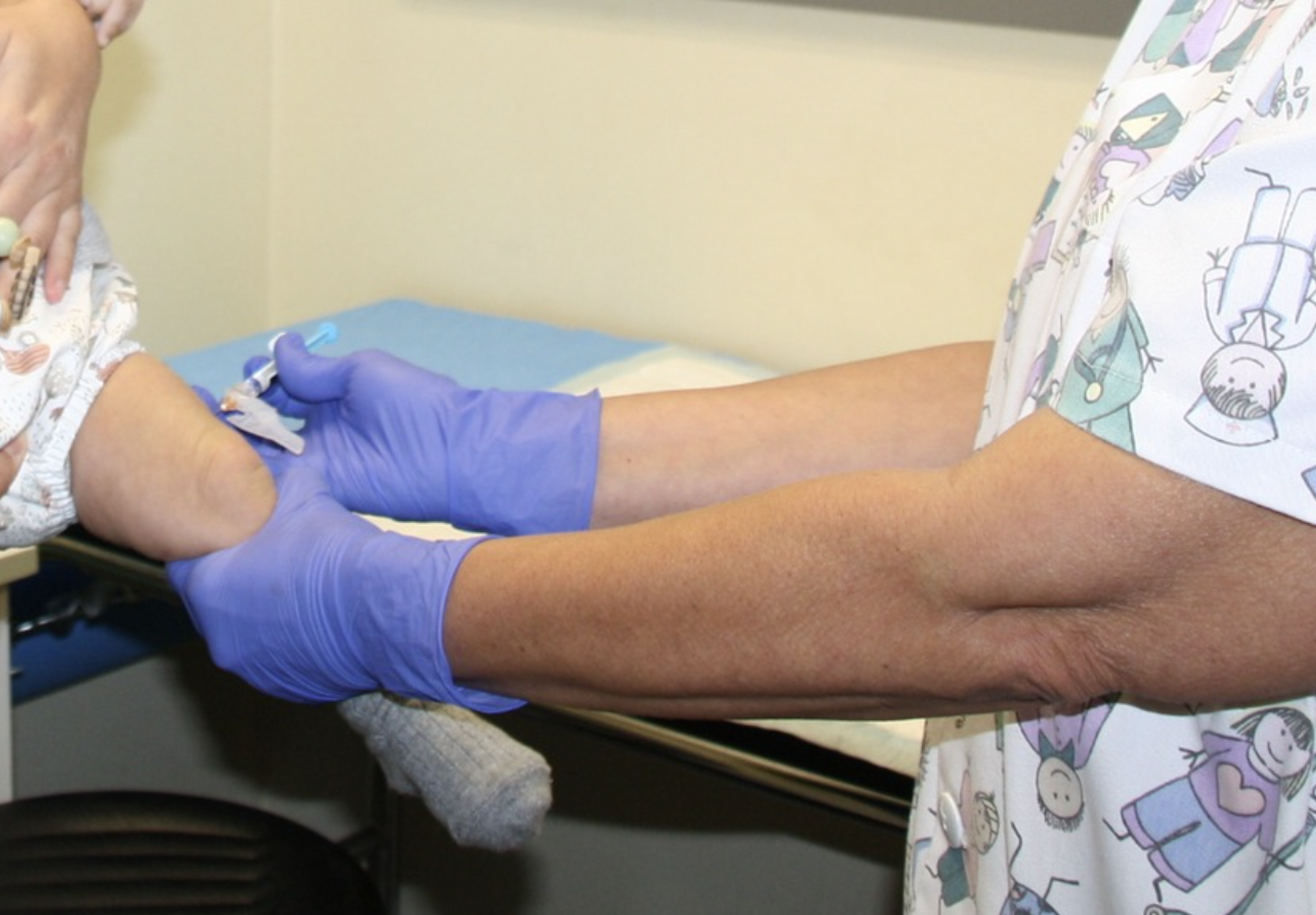 Una sanitaria pone la vacuna contra la bronquiolitis a un bebé.  