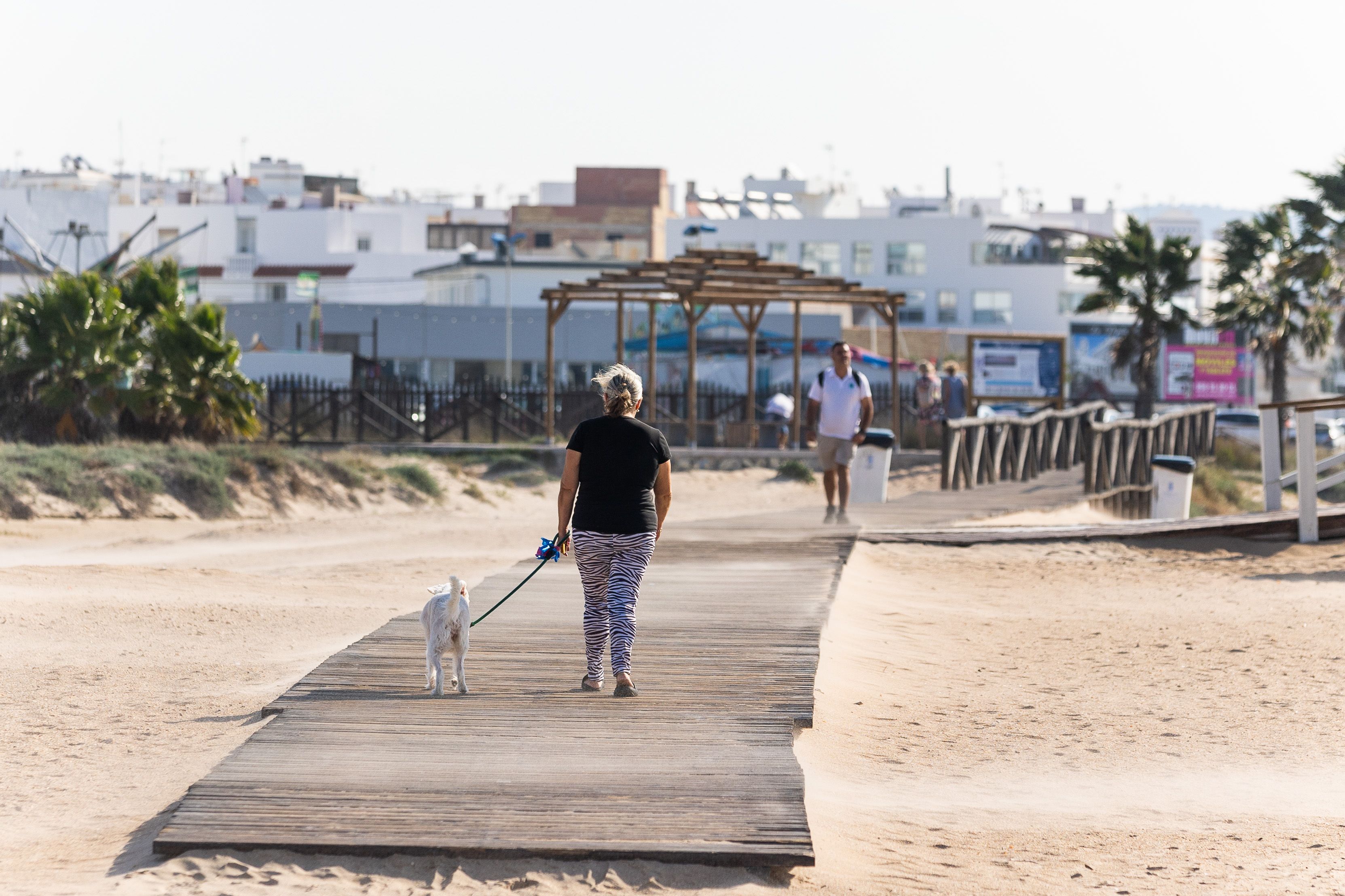 Vecinos y turistas en una de las pasarelas de acceso a la playa de Los Bateles. Vecinos y turistas en una de las pasarelas de acceso a la playa de Los Bateles.