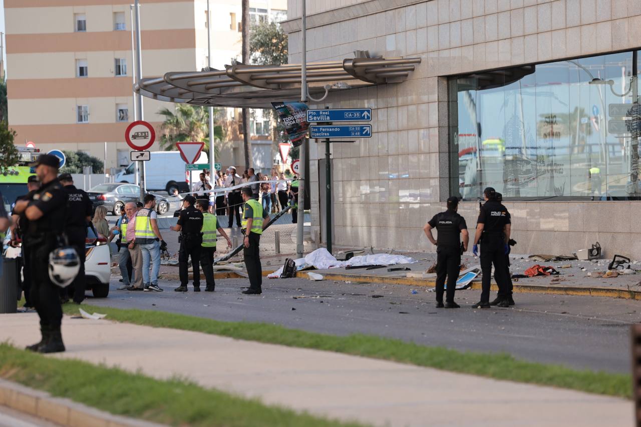Dos de las víctimas mortales yacen sobre la acera invadida por el autobús, que acoge una parada de taxi.
