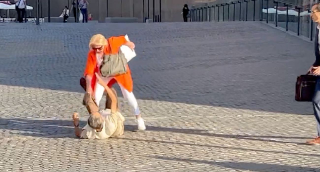 Una persona ayuda a otra tras sufrir un tropezón.