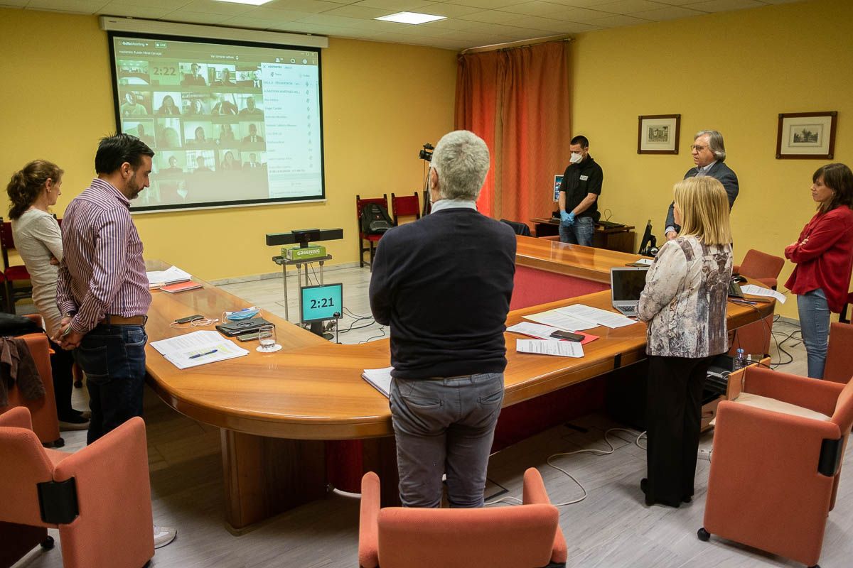 Parte del gobierno municipal, en la sala U, y el resto de la Corporación por videoconferencia, guardando tres minutos de silencio. FOTO: MANU GARCÍA