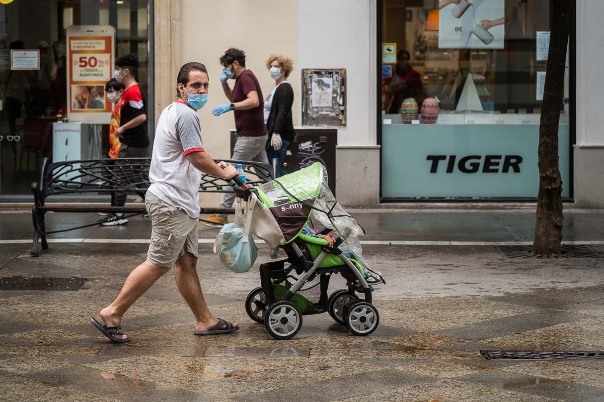 Un hombre pasea con su bebé por el centro de Jerez. FOTO: MANU GARCÍA