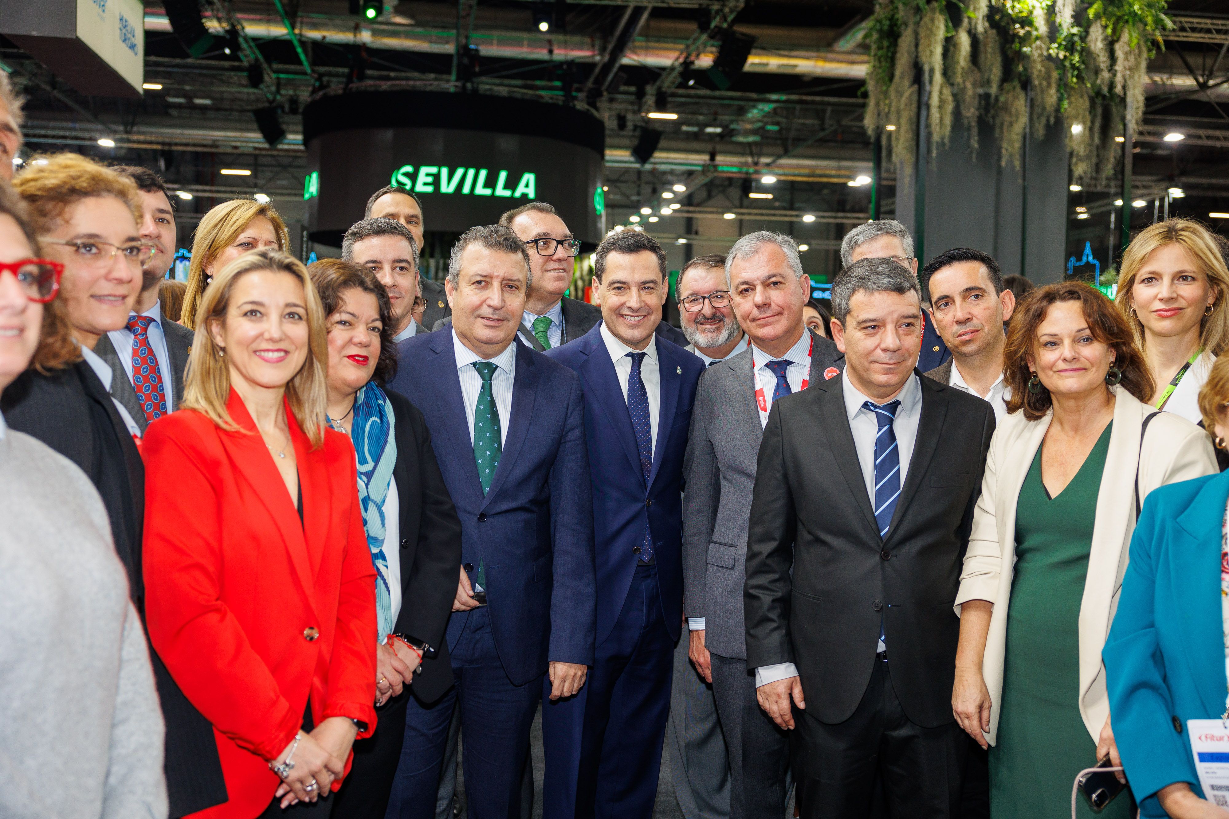 Juanma Moreno, rodeado por el presidente de Diputación, Javier Fernández, y el alcalde de Sevilla, José Luis Sanz, el miércoles en Fitur, con otros dirigentes.