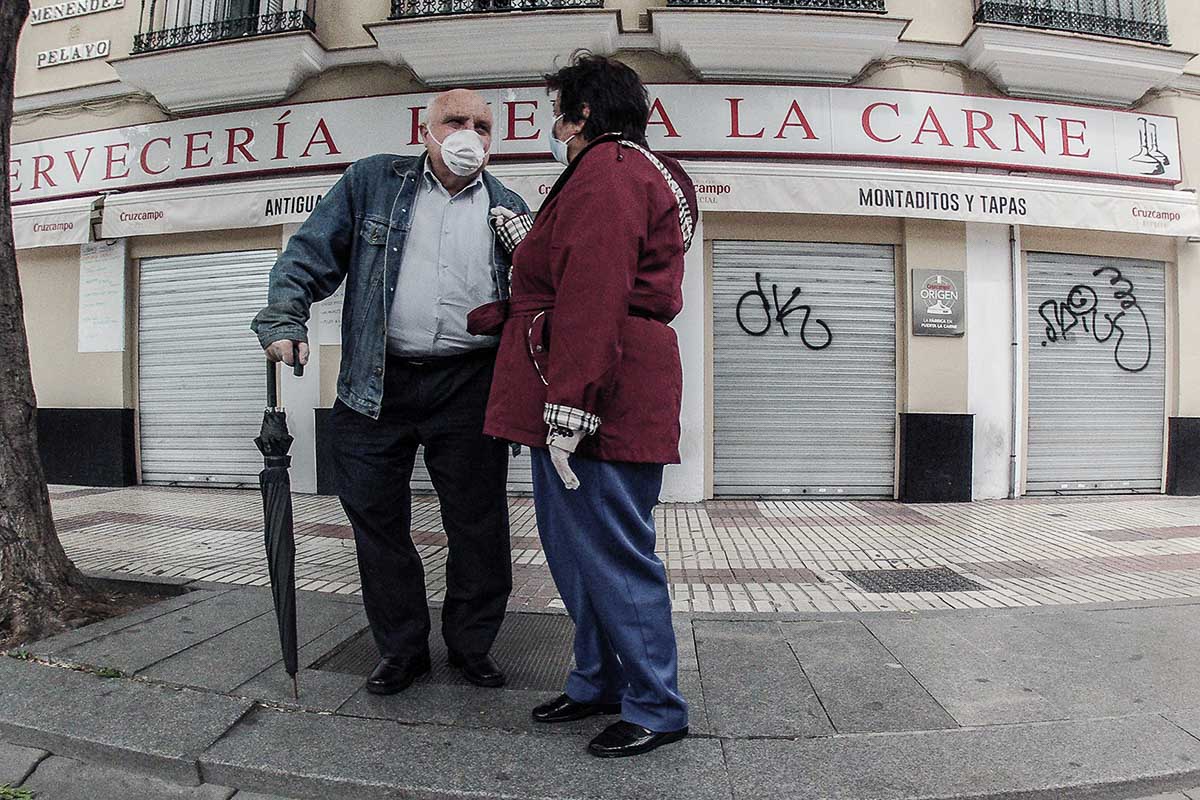 Dos personas charlando en una calle de Sevilla. FOTO: JOSÉ LUIS TIRADO (www.joseluistirado.es)