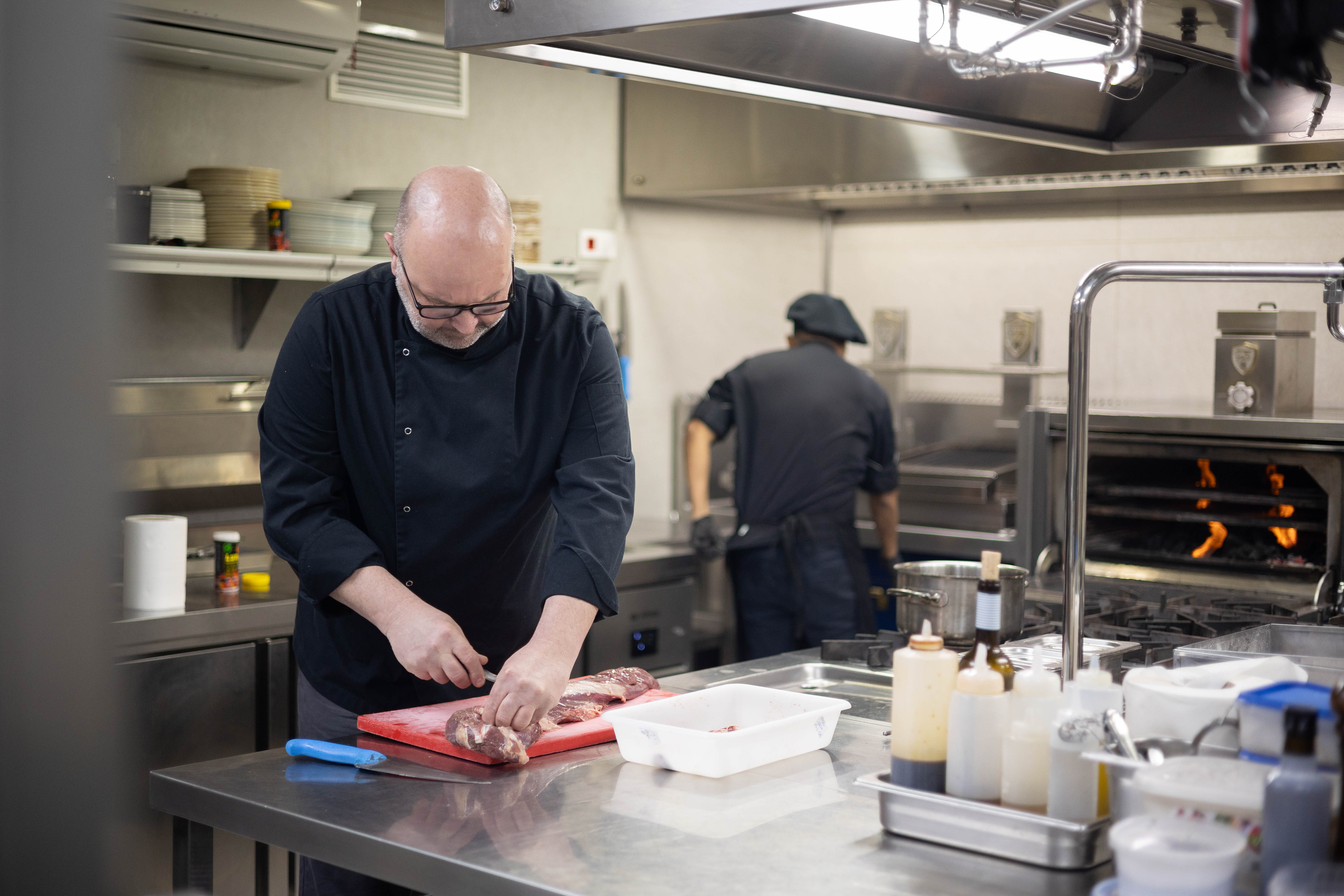 Edwin corta el solomillo en la cocina de Piparra. 