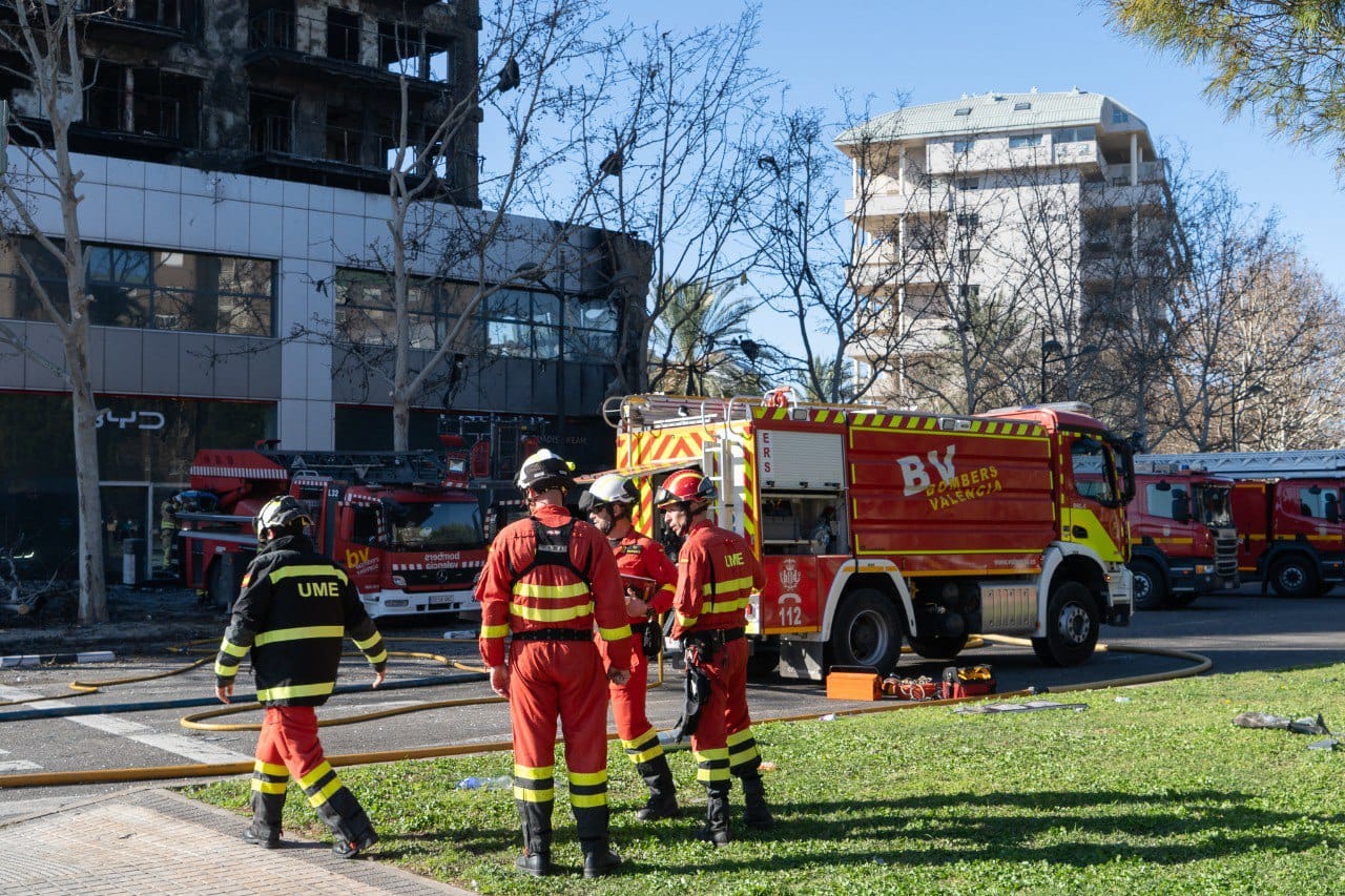 Bomberos de Valencia delante del edificio que fue pasto de las llamas en el incendio.