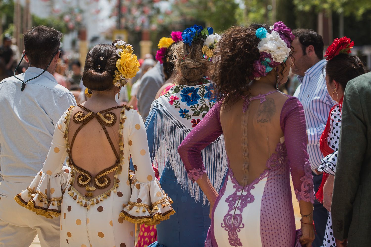 Varias mujeres, vestidas de flamenca, en la Feria del Caballo.