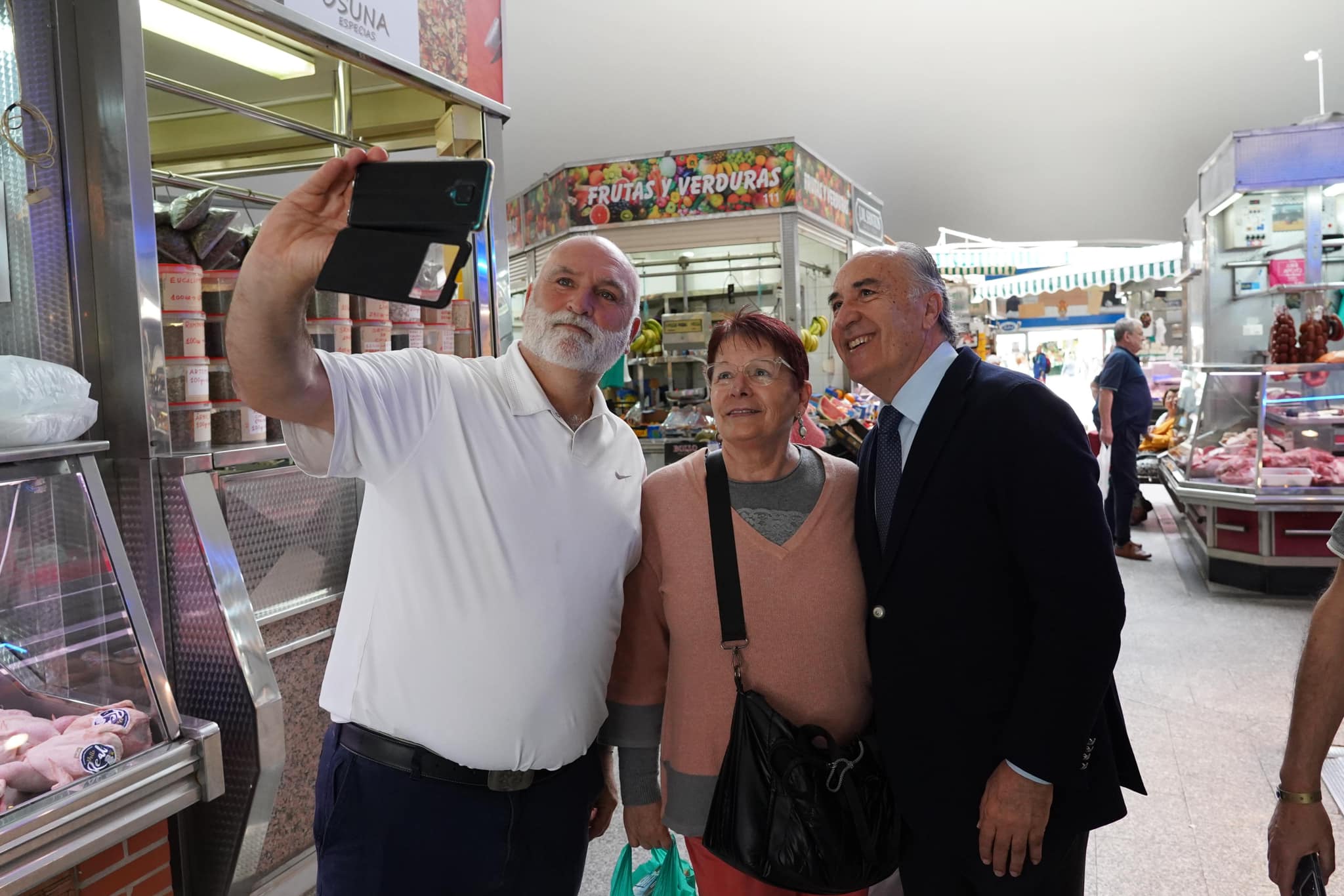José Andrés y el alcalde de Algeciras se hacen un selfie con una vecina, en el mercado de abastos de Algeciras.