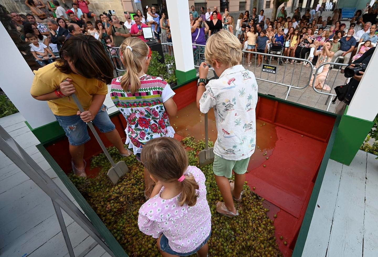 Niños y niñas en la pisa de la uva infantil organizada en las Fiestas de la Vendimia.