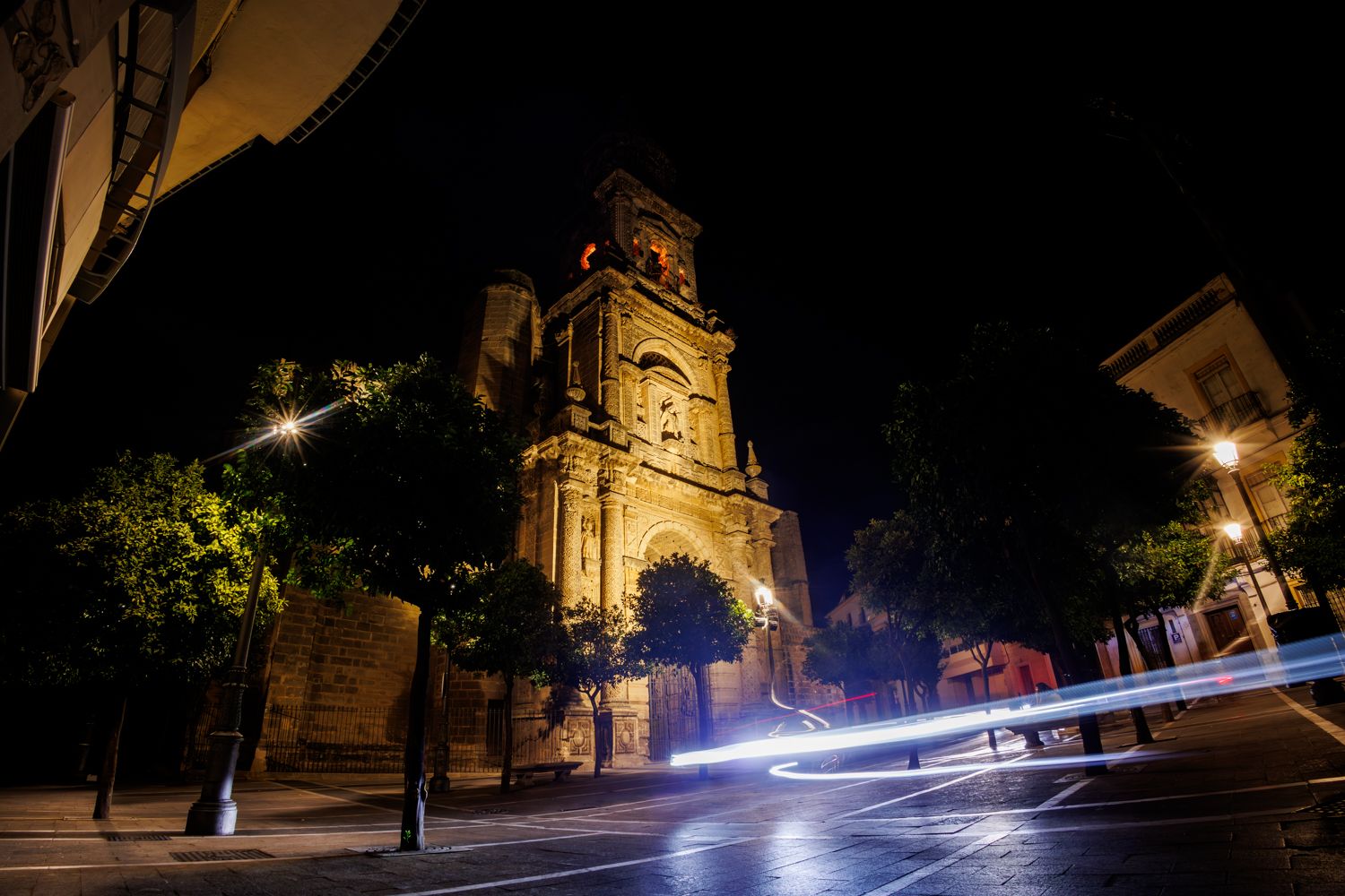 Ráfaga de luz ante la fachada semioscura de San Miguel, en Jerez.