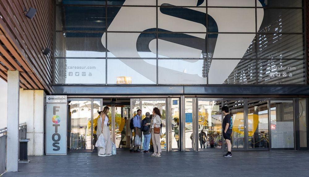 Personas saliendo del centro comercial Área Sur tras realizar sus compras.