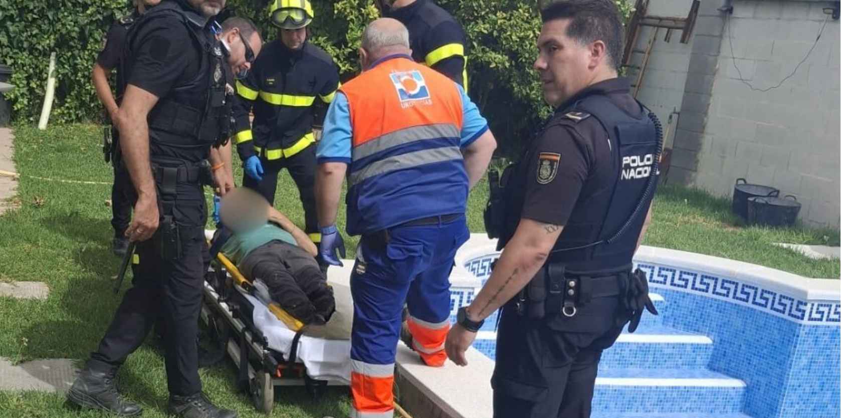 Equipos de emergencia, en las labores de rescate del hombre accidentado en una piscina.