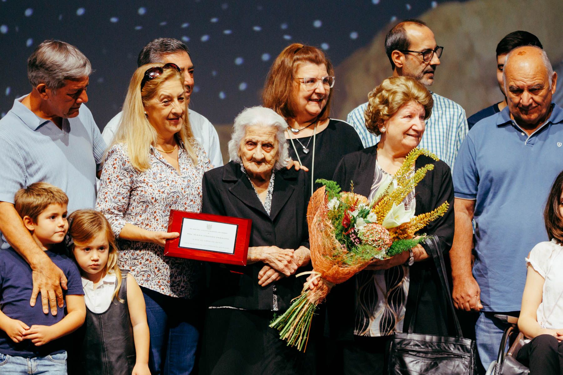 Juanita la del Curro con su familia, recogiendo la placa homenaje.