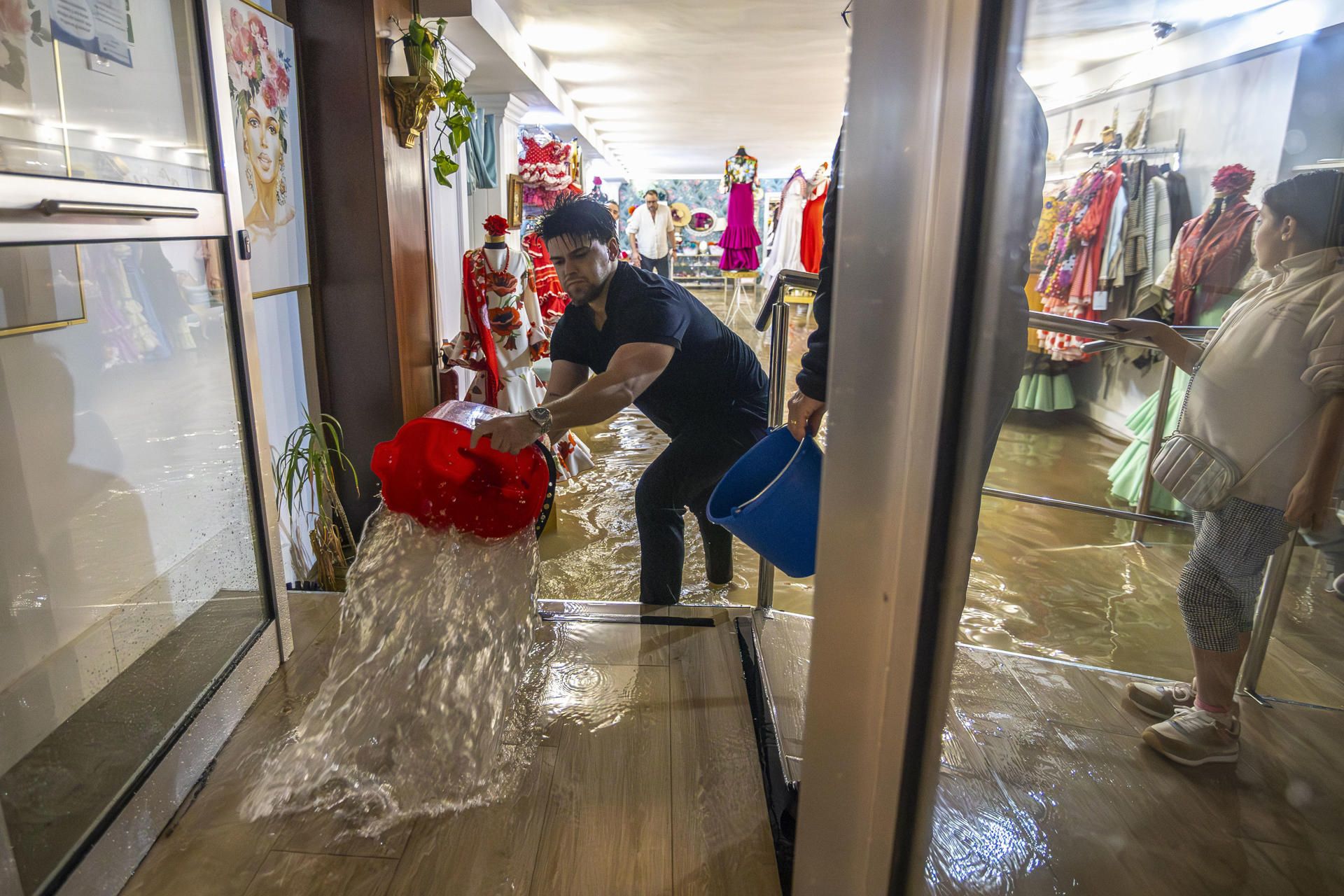 Un hombre achica agua de su negocio en Huelva, la provincia más azotada por 'Claudia'.