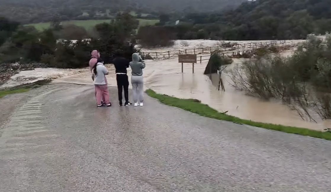 Vecinos, este pasado miércoles, en las horas previas al derrumbe total del Puente de Toleta por la crecida del Guadalete, en Puerto Serrano.