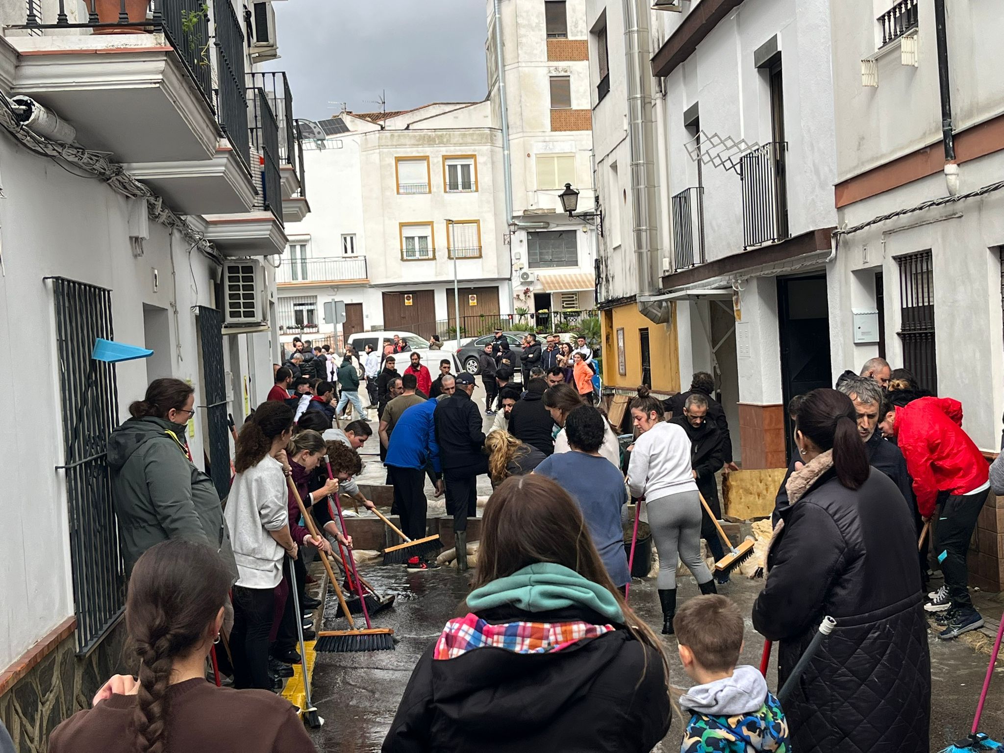 Vecinos de Ubrique, achicando agua en las calles del pueblo.