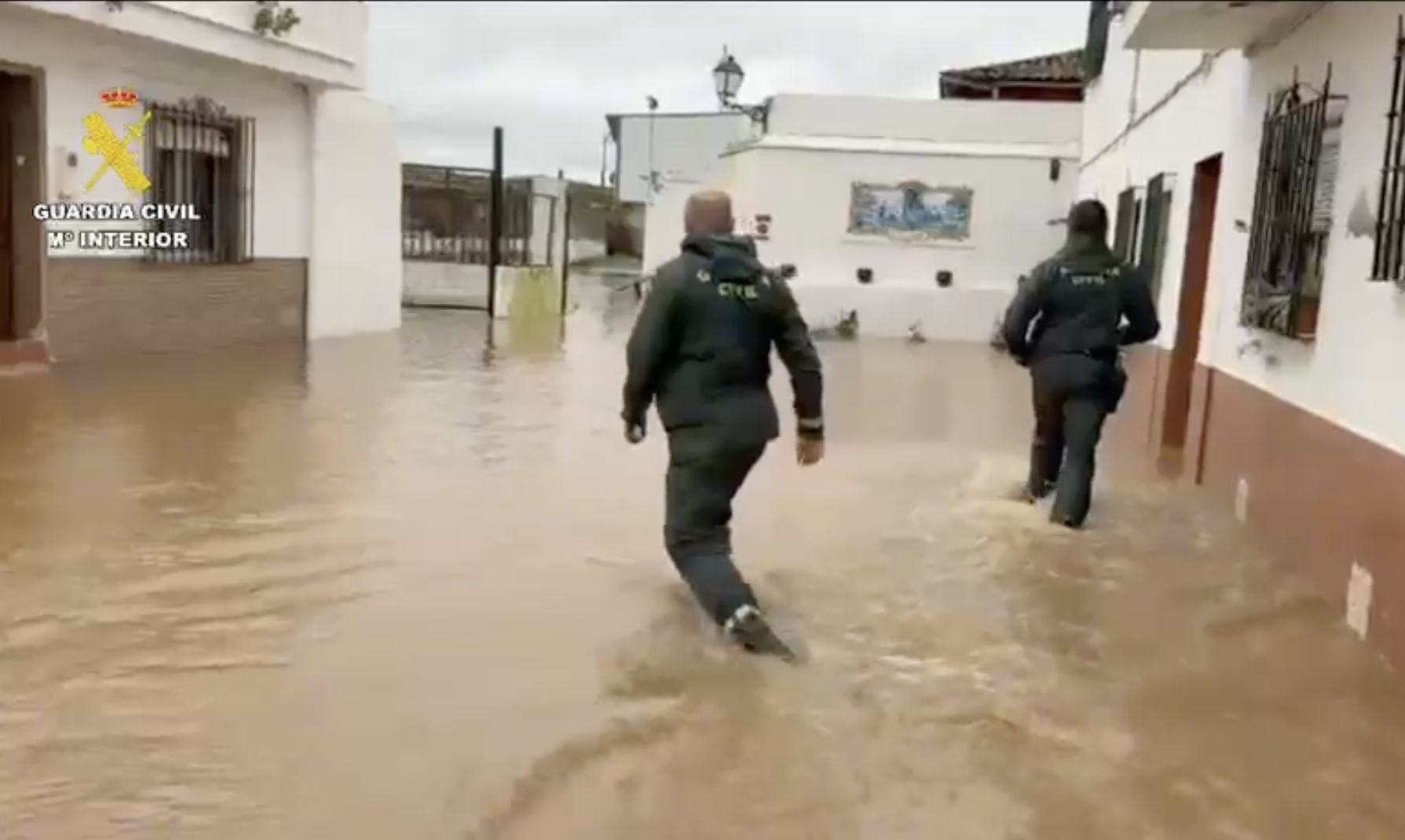 Efectivos de la Guardia Civil desalojan a vecinos de Lora del Río por el desbordamiento del arroyo Churre, afluente del Guadalquivir.