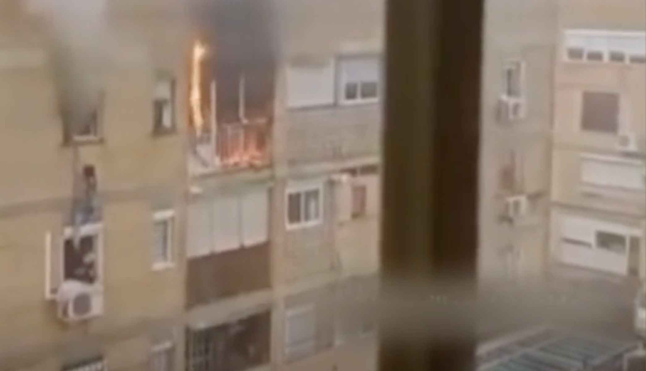 La mujer afectada por el fuego, a punto de caer al vacío. 