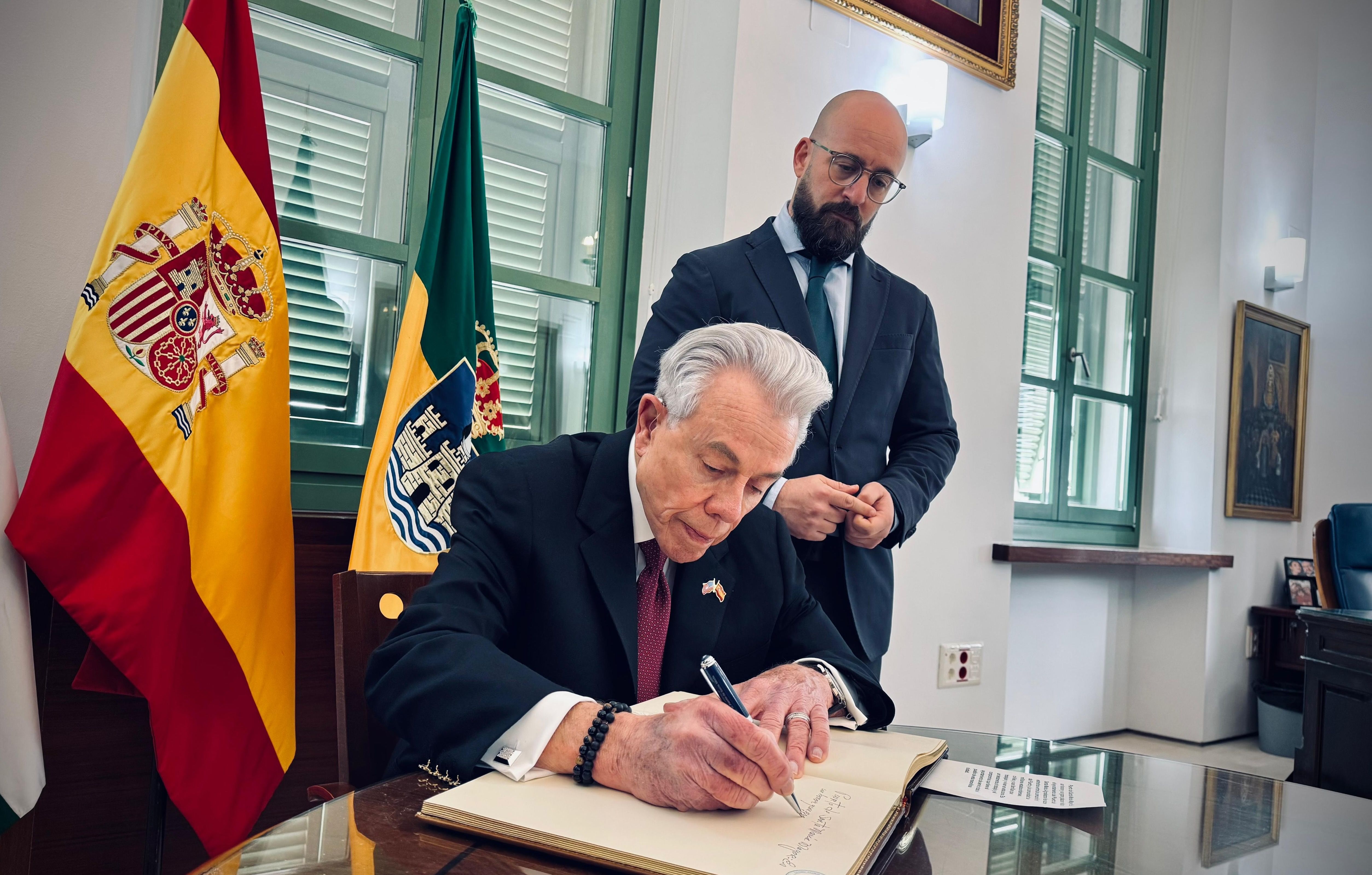 Benjamín León Jr. firma en el libro de honor de El Puerto ante la mirada, este jueves, de Germán Beardo.