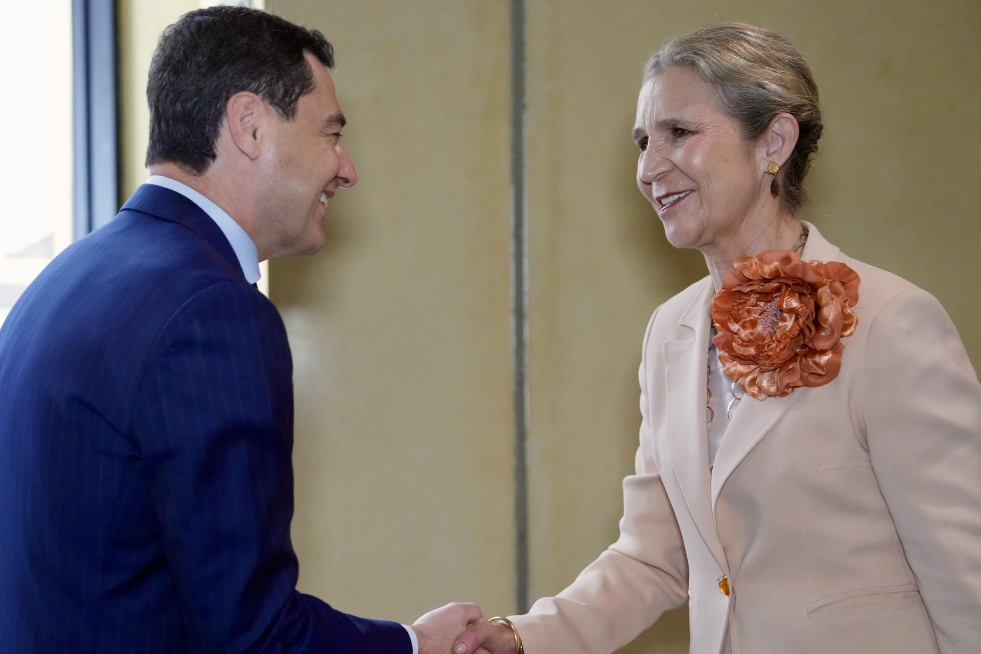 El presidente de la Junta de Andalucía, Juanma Moreno, saluda a la infanta Elena a su llegada al Teatro Maestranza para asistir al pregón taurino de la Feria de Abril, este domingo.