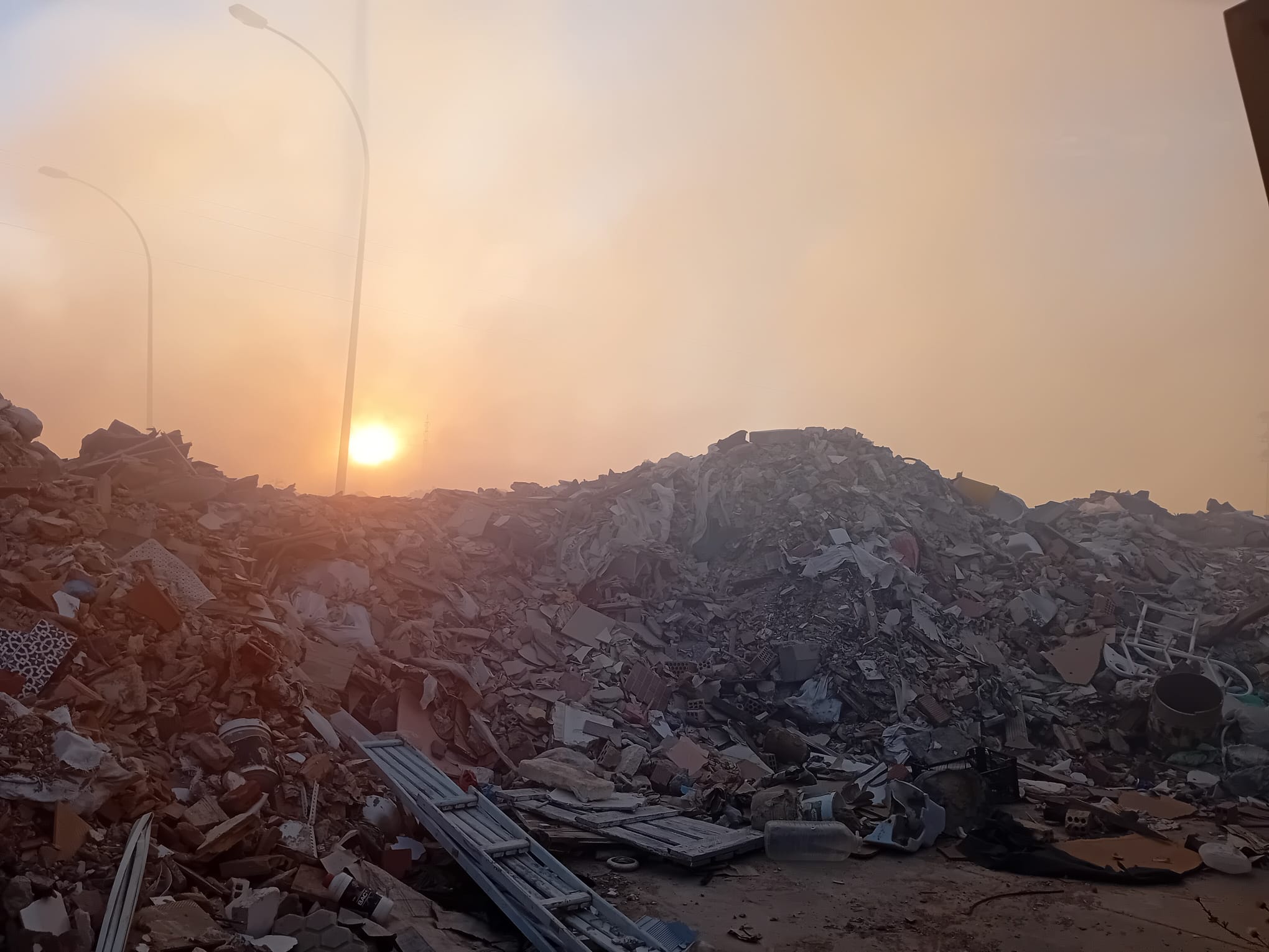 La enorme humareda que cubre el cielo de Los Palacios seguía al anochecer desde el otro lado de la escombrera del punto limpio.