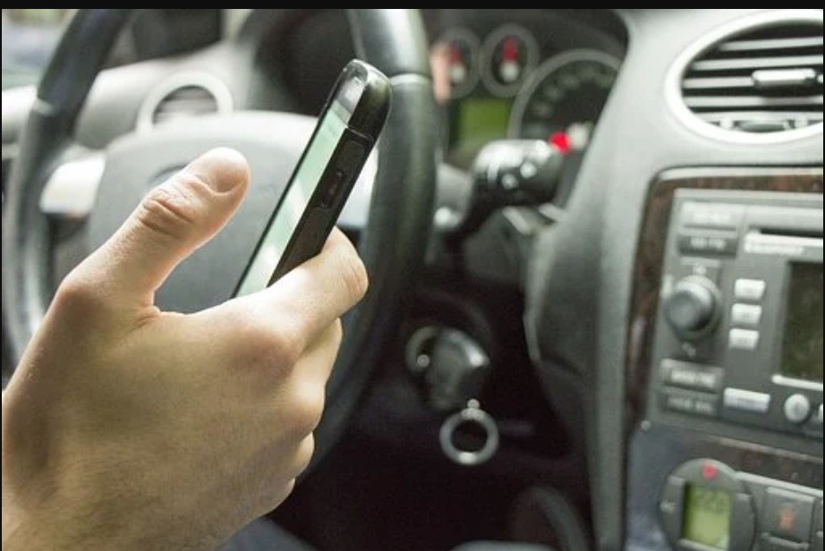Un conductor, con el móvil en la mano, en una imagen de archivo.