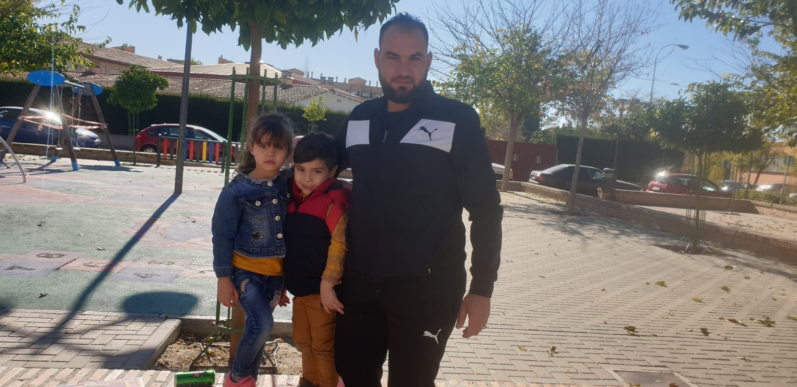 Khaled, refugiado sirio en Granada, junto a su hija, Khansa, y su hijo, Maher, a la salida de colegio.