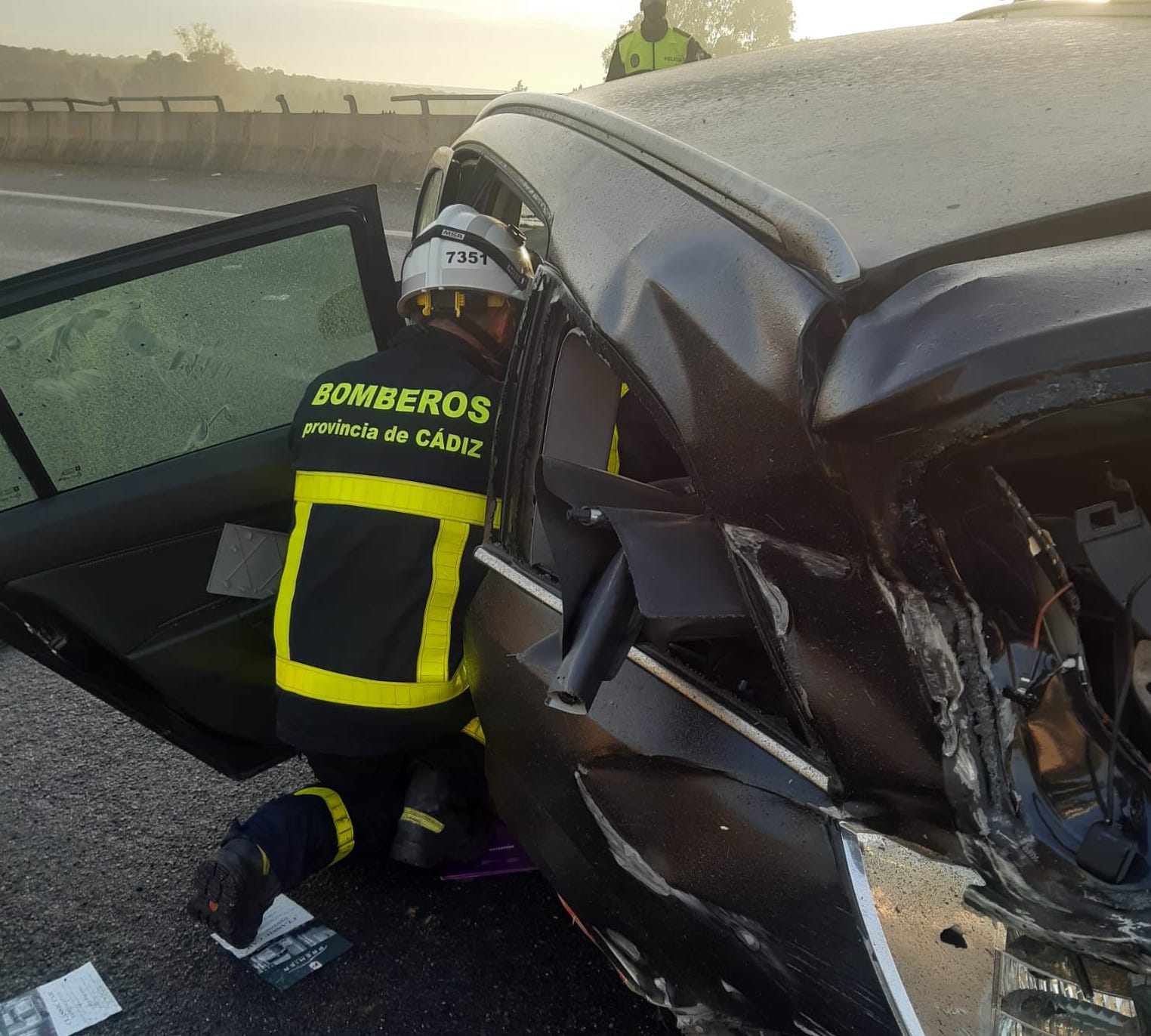 Un bombero, accediendo al vehículo tras el accidente.