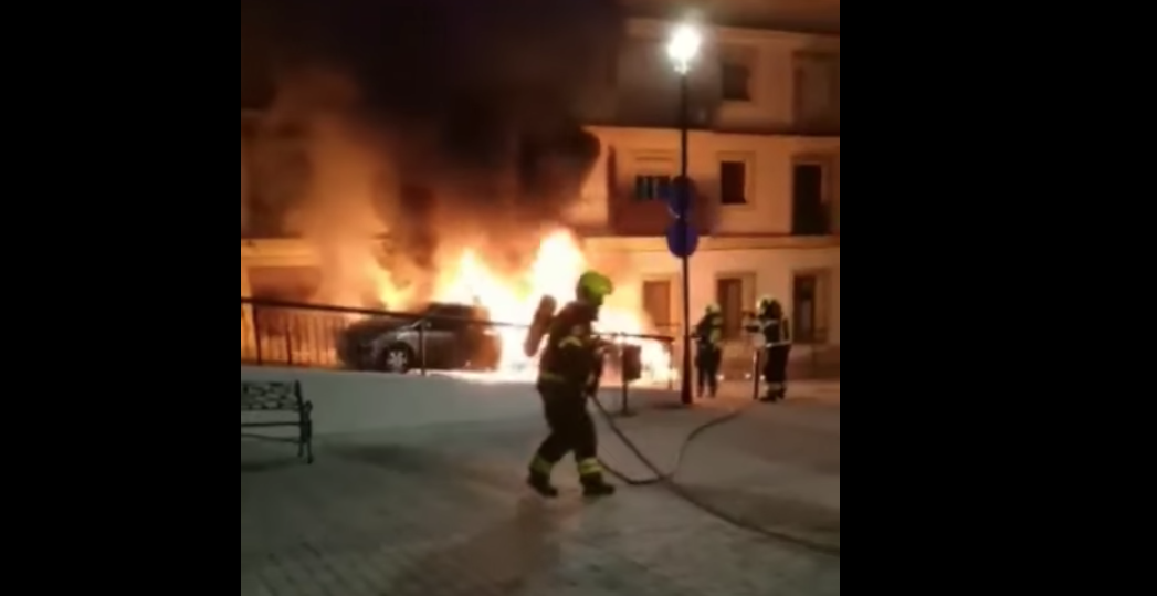 Los bomberos, extinguiendo el fuego tras el incendio provocado de dos coches en Jerez.