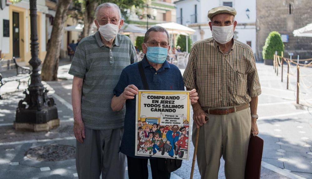 Gabriel González, Sebastián Moya y Manuel Cervera posan para lavozdelsur.es con un cartel de una campaña publicitaria del centro de Jerez.