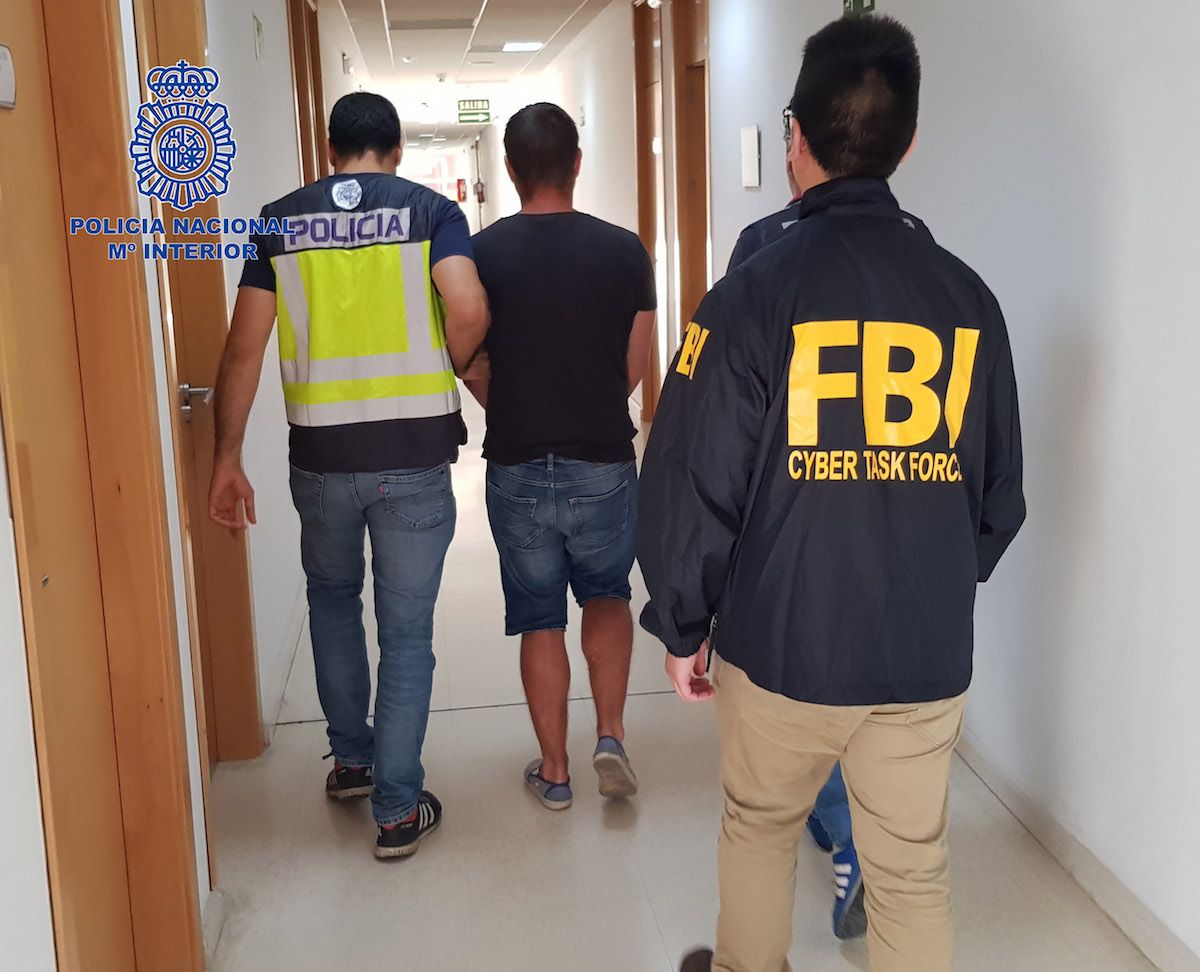 La Policía Nacional y el FBI, con el detenido.